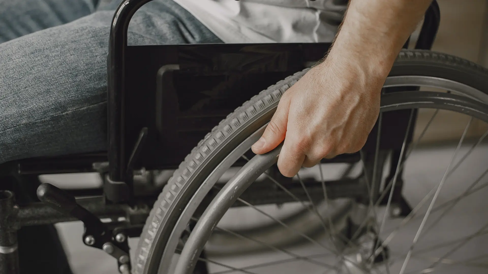 Hand on wheel of wheelchair - Physical Impairment Ireland | DPCN - Disability Participation and Consultation Network