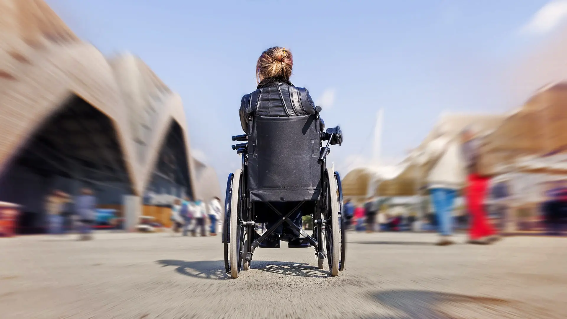 Wheelchair user navigating in busy environment - Disability Federation Ireland | DPCN - Disability Participation and Consultation Network