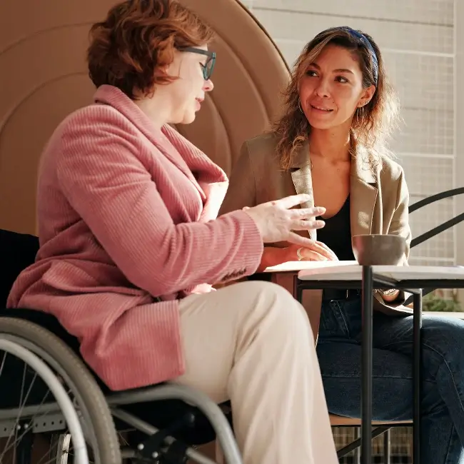 Woman in wheelchair having a one to one - Mental Health Reform | DPCN - Disability Participation and Consultation Network