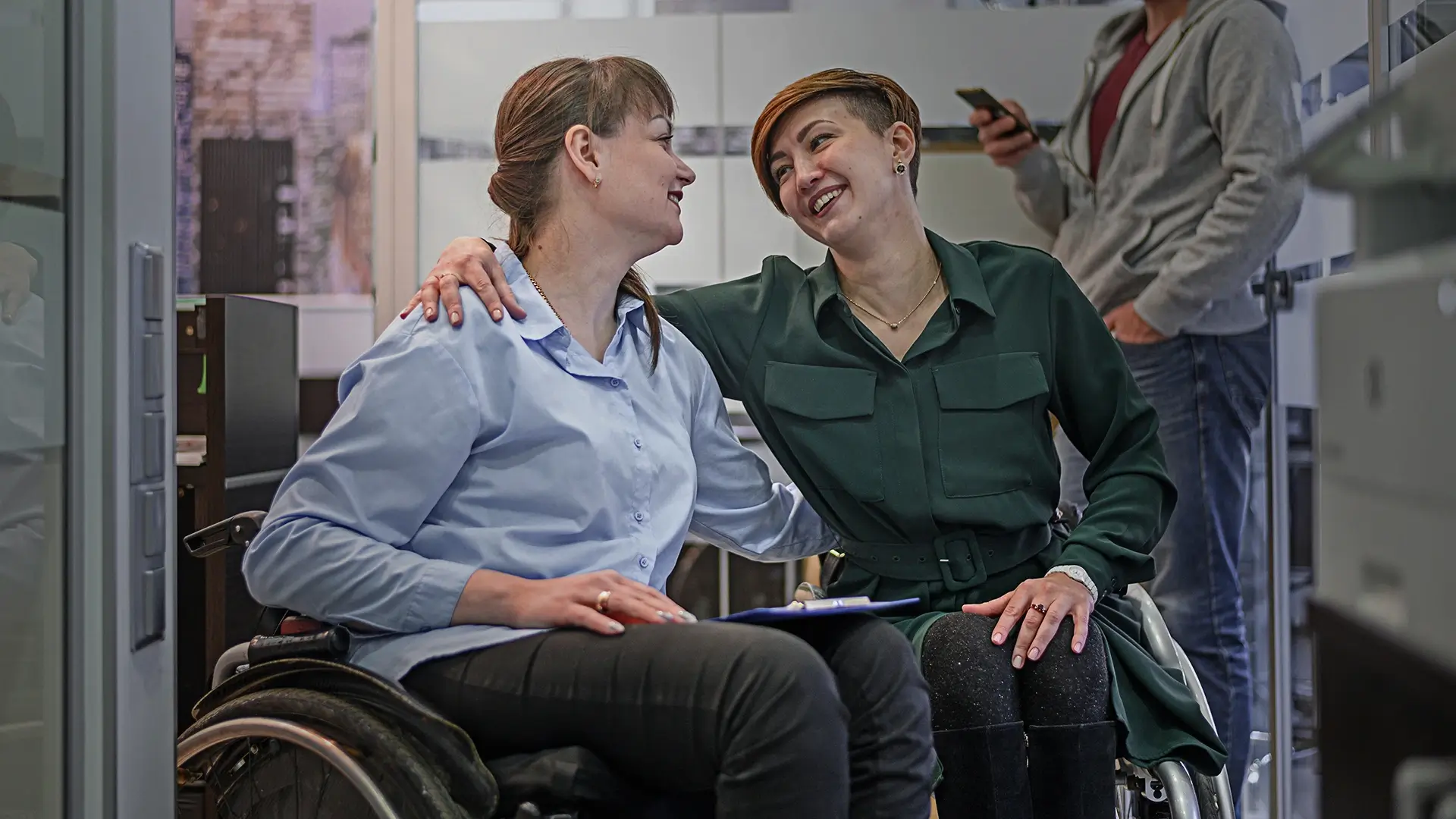 Women in wheelchair arms around one another - Disabled Women Ireland | DPCN - Disability Participation and Consultation Network