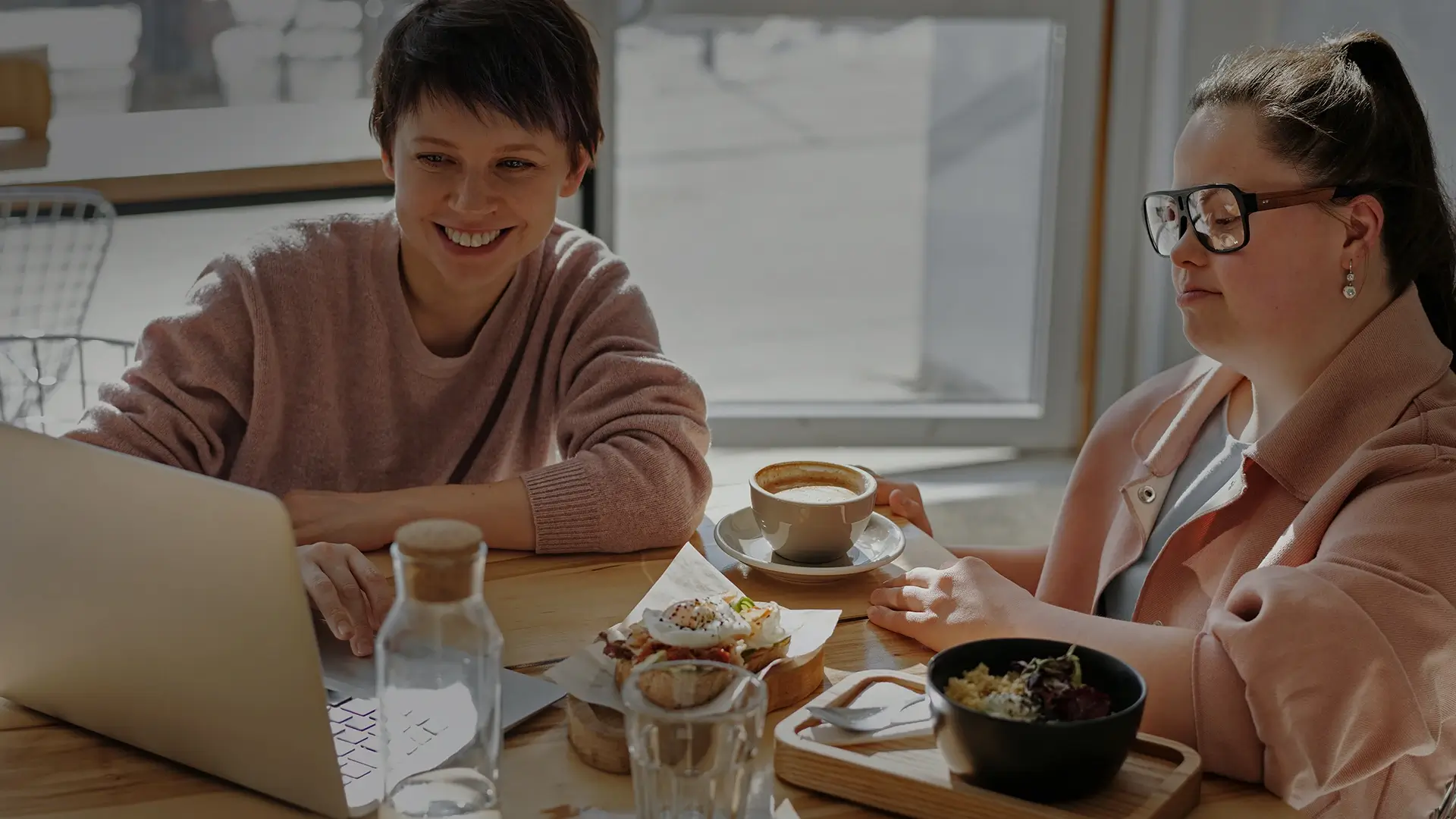 Two women looking at laptop - Disabled Women Ireland | DPCN - Disability Participation and Consultation Network